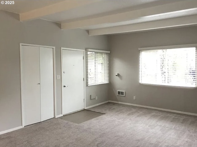 2544 NE Hoyt St, Portland, OR 97232 - unfurnished bedroom with visible vents, multiple windows, beamed ceiling, and carpet floors