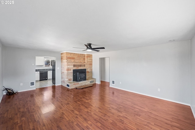 unfurnished living room with wood-type flooring and ceiling fan