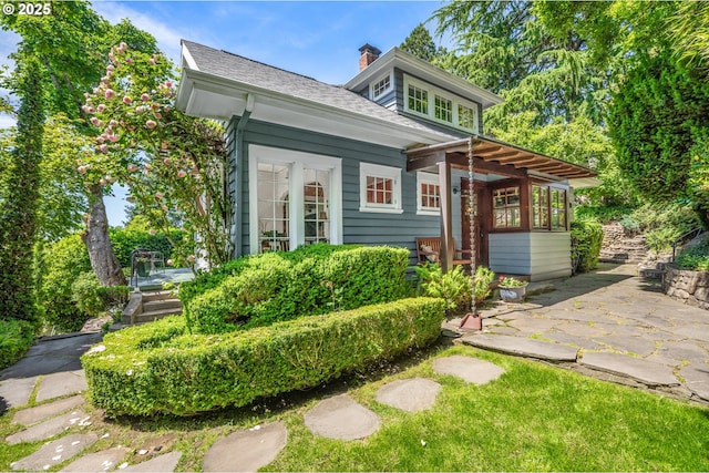 2783 NE Wiberg Ln, Portland, OR 97213 - rear view of house featuring a patio area, a chimney, and a shingled roof