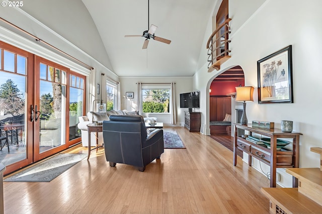 2783 NE Wiberg Ln, Portland, OR 97213 - living area with arched walkways, a ceiling fan, light wood-style floors, high vaulted ceiling, and french doors