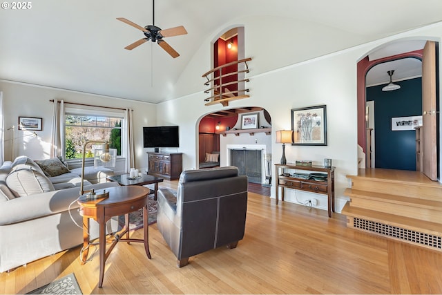 2783 NE Wiberg Ln, Portland, OR 97213 - living area with arched walkways, a ceiling fan, wood finished floors, and high vaulted ceiling