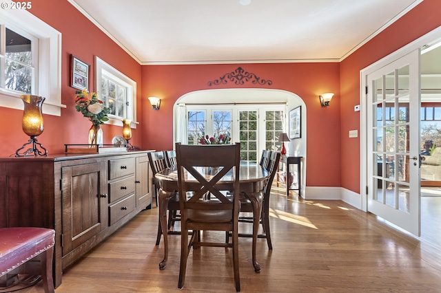 2783 NE Wiberg Ln, Portland, OR 97213 - dining area featuring wood finished floors, crown molding, healthy amount of natural light, french doors, and baseboards