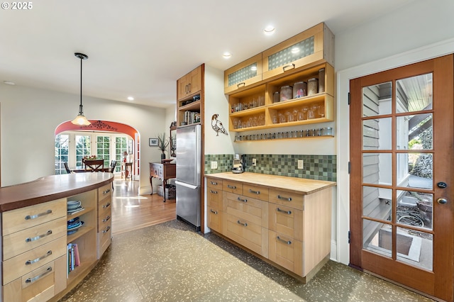 2783 NE Wiberg Ln, Portland, OR 97213 - kitchen featuring wooden counters, arched walkways, stainless steel fridge, open shelves, and backsplash
