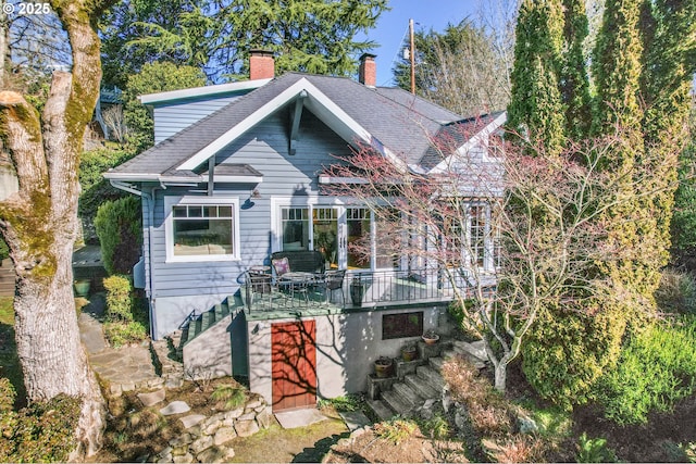 2783 NE Wiberg Ln, Portland, OR 97213 - view of front of home featuring a chimney, roof with shingles, stairs, and a deck