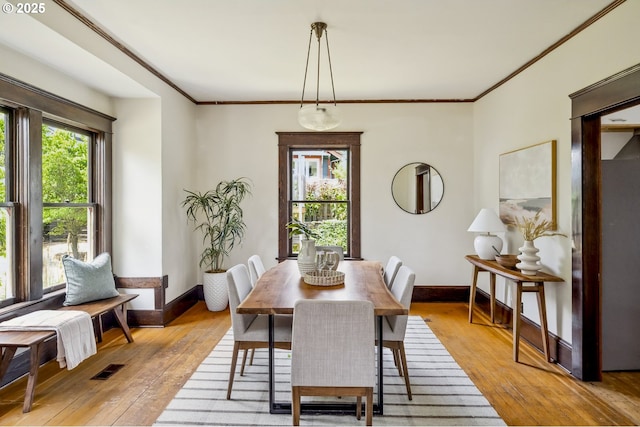 4919 NE 18th Ave, Portland, OR 97211 - dining area featuring light wood-style flooring, plenty of natural light, and ornamental molding