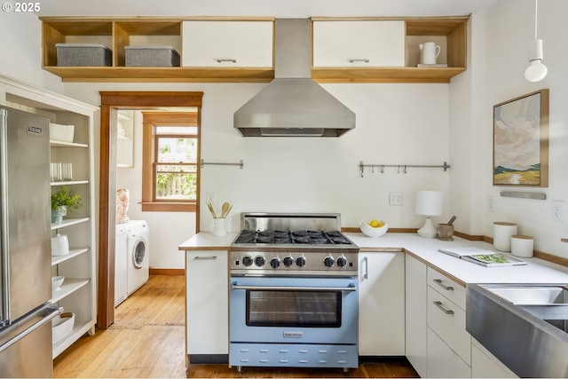 4919 NE 18th Ave, Portland, OR 97211 - kitchen with stainless steel appliances, independent washer and dryer, island range hood, open shelves, and light countertops