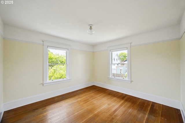4919 NE 18th Ave, Portland, OR 97211 - spare room featuring healthy amount of natural light and hardwood / wood-style flooring
