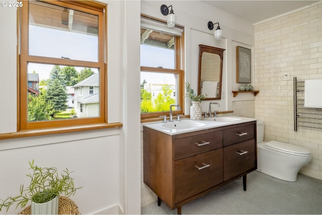 4919 NE 18th Ave, Portland, OR 97211 - bathroom with tile walls, double vanity, and tile patterned floors