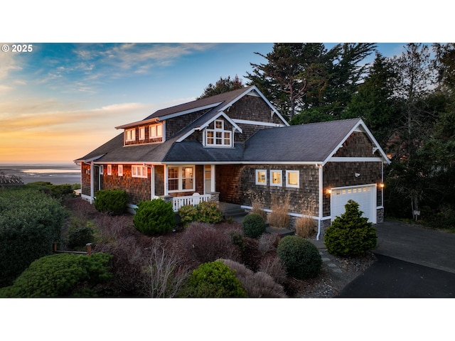 craftsman house with a garage, covered porch, and aphalt driveway