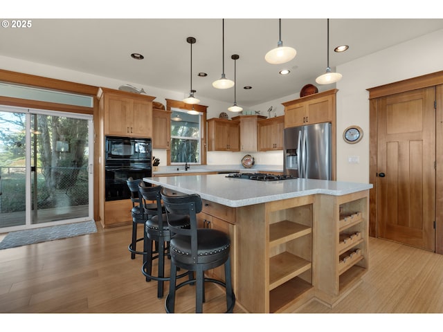 kitchen featuring open shelves, a sink, light countertops, a center island, and black appliances