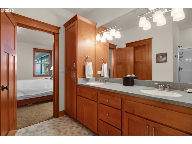 bathroom with connected bathroom, double vanity, tile patterned floors, and a sink