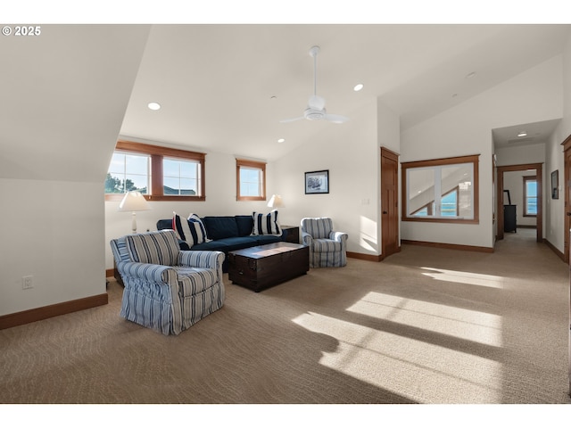 living room featuring carpet floors, a ceiling fan, baseboards, and vaulted ceiling