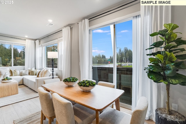dining area featuring light wood-style flooring and recessed lighting