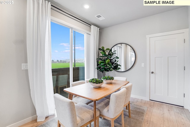 dining area featuring light wood-type flooring, baseboards, and recessed lighting