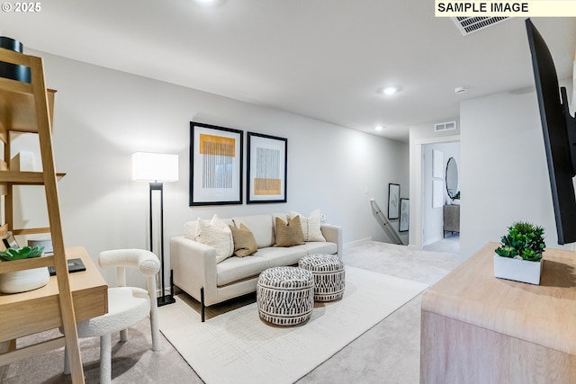 living area featuring recessed lighting and light carpet