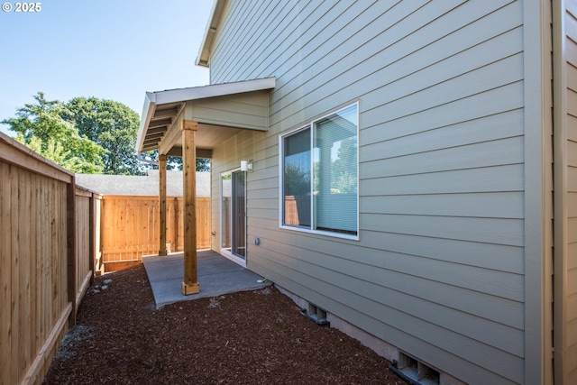 view of side of property with a fenced backyard and a patio