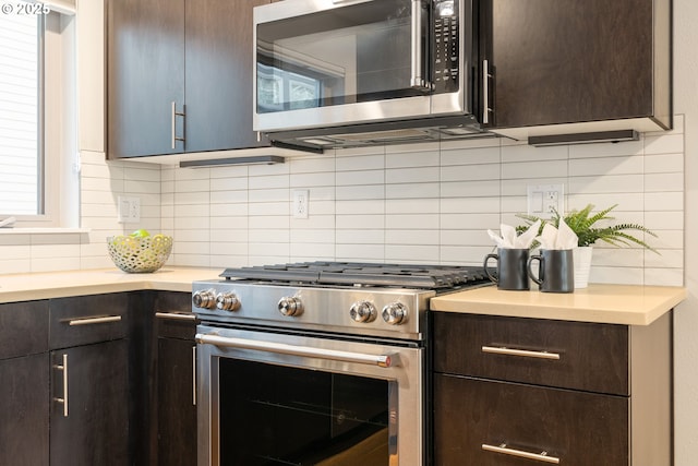 kitchen with decorative backsplash, dark brown cabinetry, appliances with stainless steel finishes, and light countertops