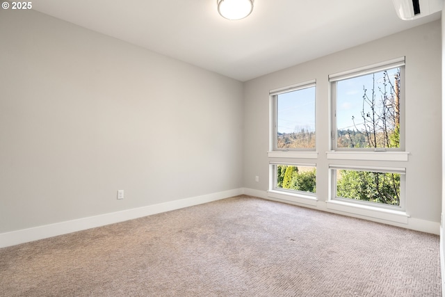 carpeted empty room with baseboards