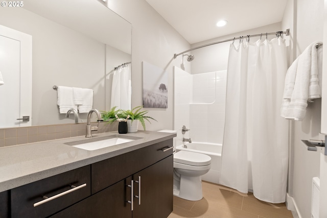 bathroom featuring toilet, vanity, and shower / bath combination with curtain