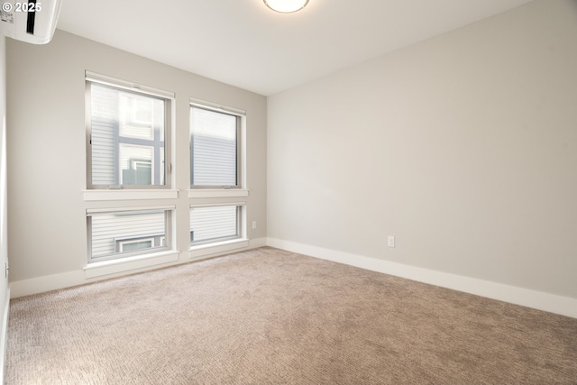 carpeted spare room with baseboards