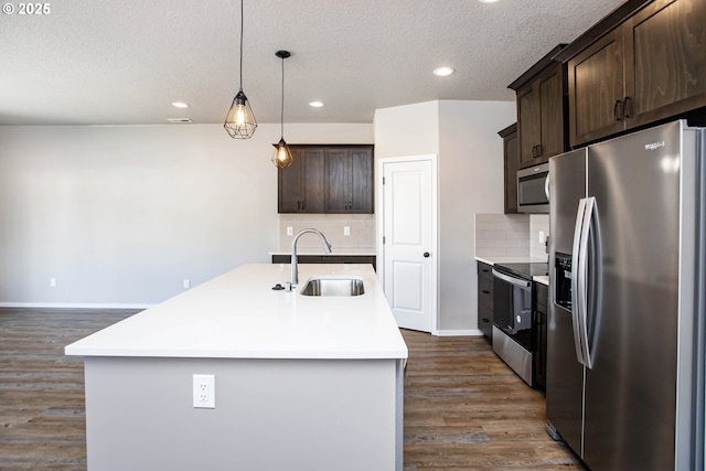 kitchen featuring stainless steel appliances, dark wood-style flooring, a sink, and dark brown cabinets