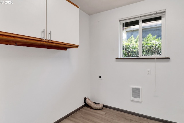 70 Jefferson Aly, Eugene, OR 97402 - washroom with cabinet space, electric dryer hookup, light wood-style flooring, baseboards, and heating unit