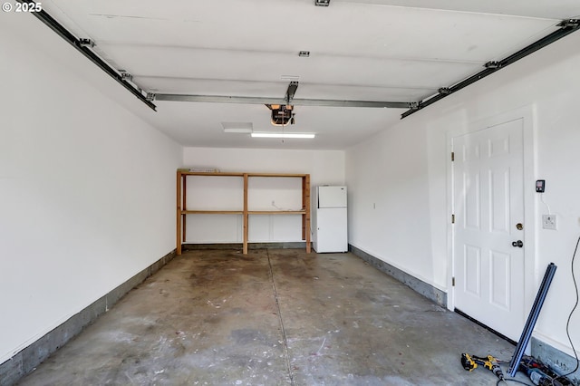 70 Jefferson Aly, Eugene, OR 97402 - garage with freestanding refrigerator, a garage door opener, and baseboards