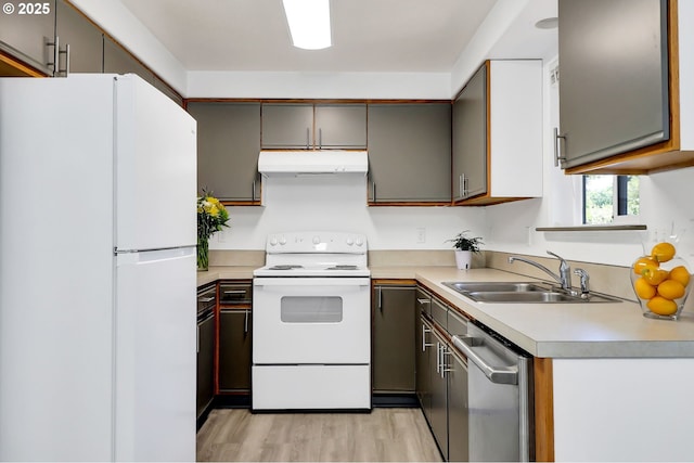 70 Jefferson Aly, Eugene, OR 97402 - kitchen with white appliances, a sink, under cabinet range hood, light wood-type flooring, and light countertops