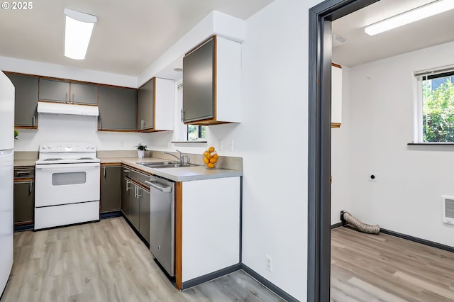 70 Jefferson Aly, Eugene, OR 97402 - kitchen featuring white range with electric cooktop, under cabinet range hood, stainless steel dishwasher, light wood finished floors, and light countertops