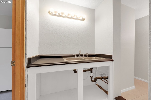 bathroom with sink and tile patterned flooring