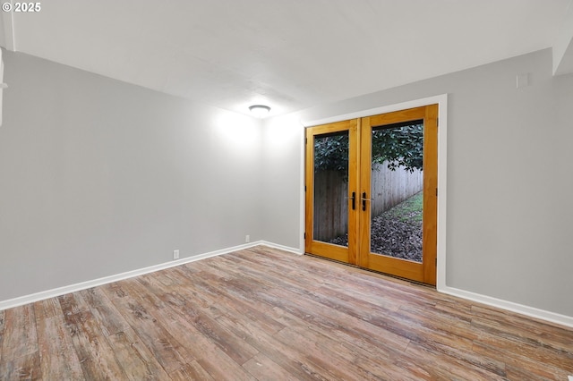 unfurnished room featuring light hardwood / wood-style flooring and french doors