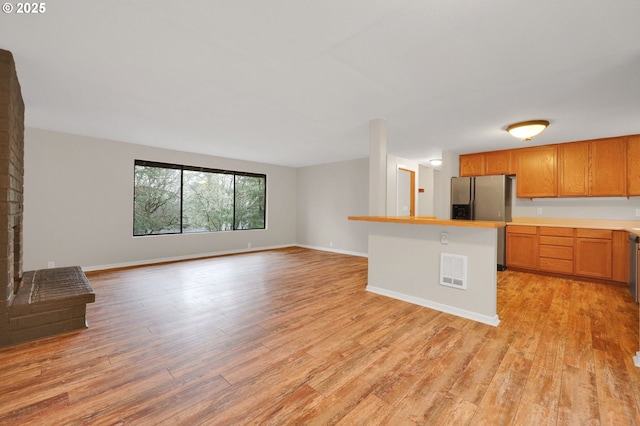 kitchen with stainless steel refrigerator with ice dispenser and light hardwood / wood-style floors