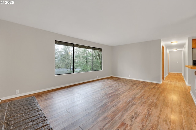 unfurnished room with light wood-type flooring