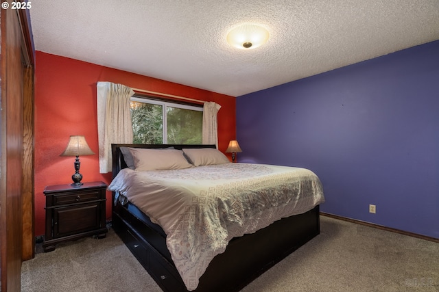 bedroom featuring baseboards, a textured ceiling, and light colored carpet