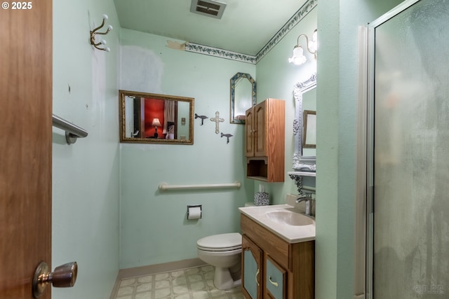 bathroom featuring visible vents, toilet, vanity, a shower stall, and tile patterned floors