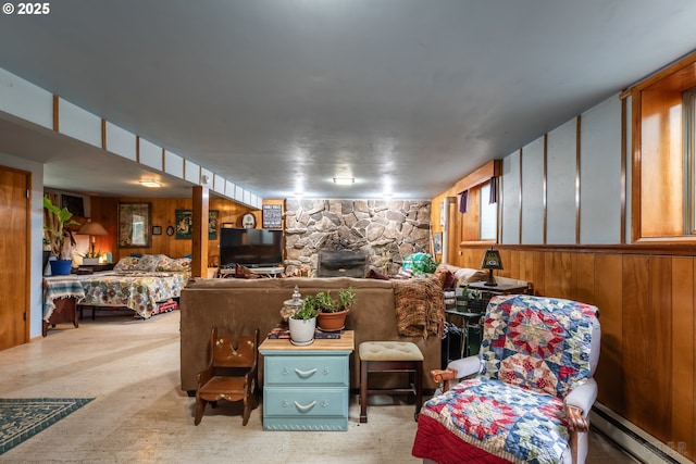 living room featuring a baseboard radiator, a fireplace, and wooden walls