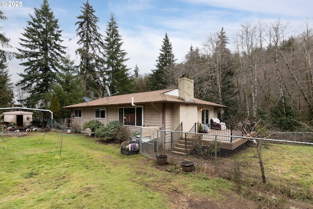 back of property featuring a yard, a chimney, and fence