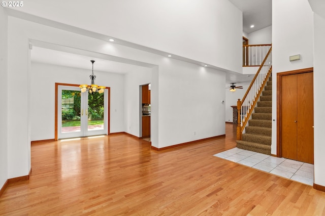 4060 Hampshire Ln, Eugene, OR 97404 - unfurnished living room with light wood finished floors, stairs, a chandelier, and recessed lighting