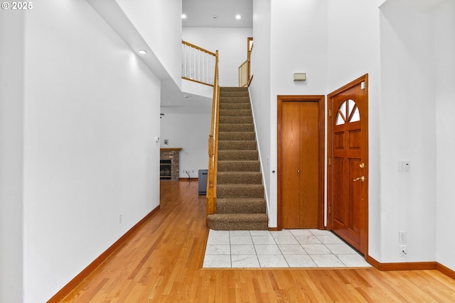 4060 Hampshire Ln, Eugene, OR 97404 - entrance foyer with a high ceiling, stairs, light wood-type flooring, a fireplace, and recessed lighting