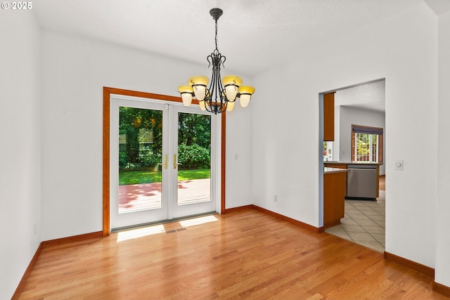 4060 Hampshire Ln, Eugene, OR 97404 - spare room featuring a chandelier, light wood-type flooring, and french doors