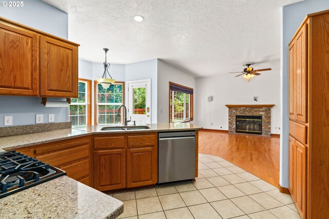 4060 Hampshire Ln, Eugene, OR 97404 - kitchen featuring stainless steel dishwasher, a peninsula, ceiling fan, brown cabinetry, and a textured ceiling