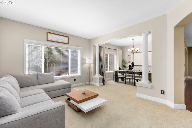 15655 SW Greenfield Dr, Portland, OR 97224 - living room featuring decorative columns, arched walkways, a chandelier, and carpet flooring