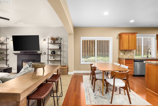 15655 SW Greenfield Dr, Portland, OR 97224 - dining area with light wood-type flooring, recessed lighting, and a tiled fireplace