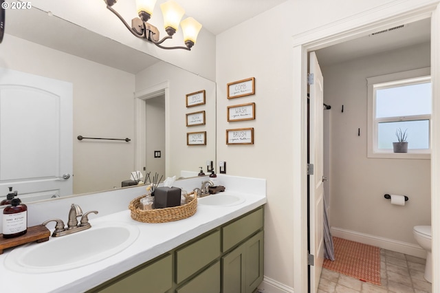 15655 SW Greenfield Dr, Portland, OR 97224 - bathroom featuring double vanity and a chandelier