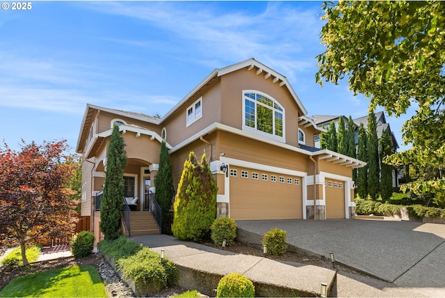 15655 SW Greenfield Dr, Portland, OR 97224 - view of front of property featuring a garage, stone siding, concrete driveway, and stucco siding