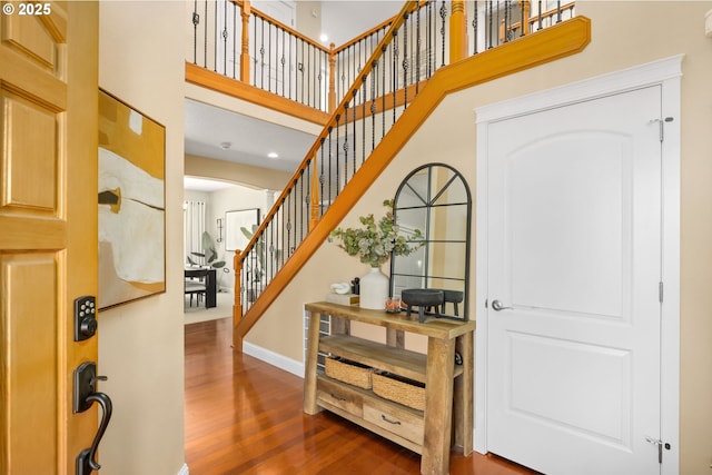 15655 SW Greenfield Dr, Portland, OR 97224 - foyer entrance featuring a high ceiling, dark wood-style flooring, arched walkways, stairs, and recessed lighting