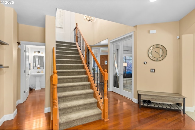 15655 SW Greenfield Dr, Portland, OR 97224 - stairway with wood finished floors and a chandelier