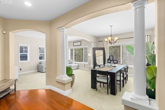 15655 SW Greenfield Dr, Portland, OR 97224 - dining area featuring ornate columns, arched walkways, carpet flooring, wood finished floors, and recessed lighting