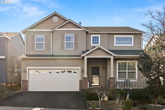 craftsman house featuring an attached garage, concrete driveway, and brick siding