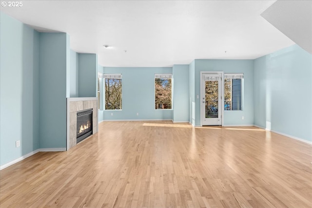 unfurnished living room featuring light hardwood / wood-style flooring and a fireplace